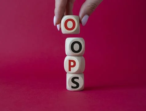 Oops symbol. Concept word Oops on wooden cubes. Businessman hand. Beautiful.. Stock Photos