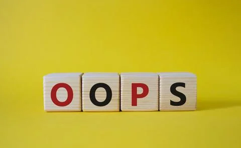 Oops symbol. Concept word Oops on wooden cubes. Beautiful yellow background.. Foto stock