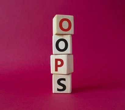 Oops symbol. Concept word Oops on wooden cubes. Beautiful red background. B.. Foto stock
