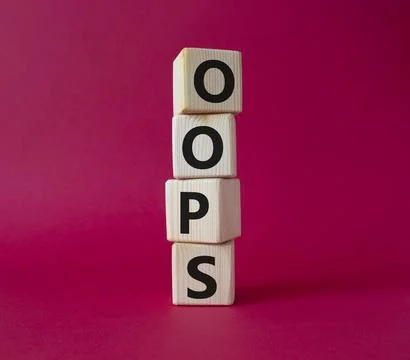 Oops symbol. Concept word Oops on wooden cubes. Beautiful red background. Bus Stock Photos