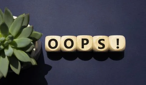 Oops symbol. Concept word Oops on wooden cubes. Beautiful deep blue backgro.. Foto stock