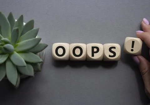 Oops symbol. Concept word Oops on wooden cubes. Businessman hand. Beautiful g Foto stock