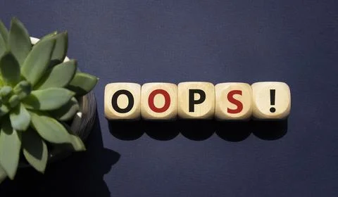 Oops symbol. Concept word Oops on wooden cubes. Beautiful deep blue backgro.. Foto stock