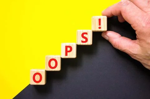 Oops symbol. Concept word Oops on beautiful wooden blocks. Beautiful yellow.. 스톡 사진