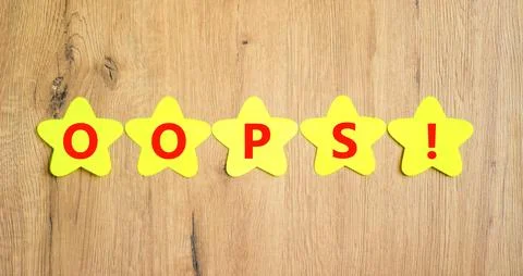 Oops symbol. Concept word Oops on beautiful yellow paper stars. Beautiful woo 스톡 사진
