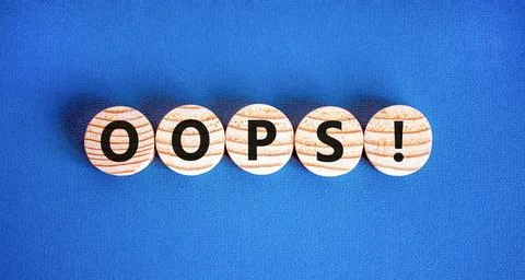 Oops symbol. Concept word Oops on beautiful wooden circles. Beautiful blue .. Stock Photos