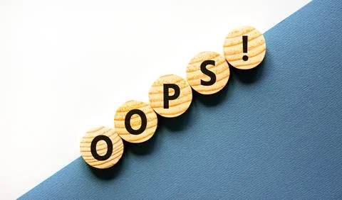 Oops symbol. Concept word Oops on beautiful wooden circles. Beautiful blue .. Stock Photos