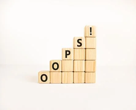 Oops symbol. Concept word Oops on beautiful wooden blocks. Beautiful white .. Stock Photos
