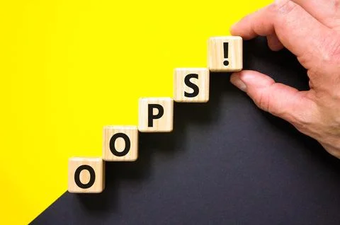 Oops symbol. Concept word Oops on beautiful wooden blocks. Beautiful yellow.. Stock Photos