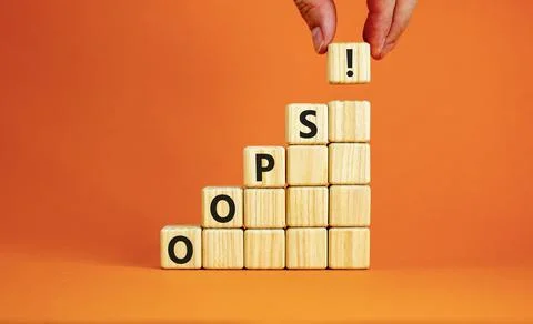 Oops symbol. Concept word Oops on beautiful wooden blocks. Beautiful orange.. Stock Photos