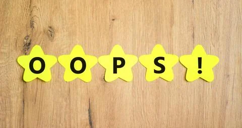 Oops symbol. Concept word Oops on beautiful yellow paper stars. Beautiful woo Stock Photos