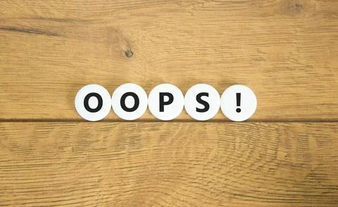 Oops symbol. Concept word Oops on beautiful white circles. Beautiful wooden.. Stock Photos
