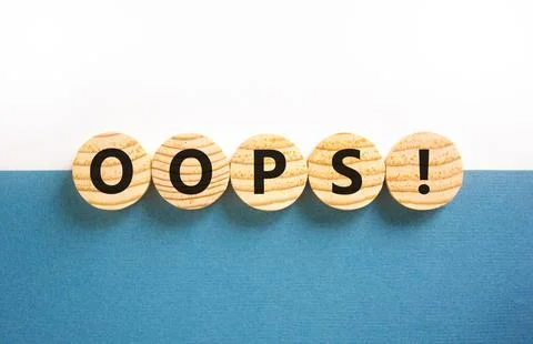 Oops symbol. Concept word Oops on beautiful wooden circles. Beautiful blue .. Stock Photos
