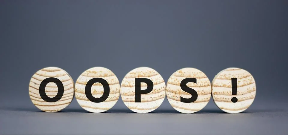 Oops symbol. Concept word Oops on beautiful wooden circles. Beautiful grey .. Stock Photos