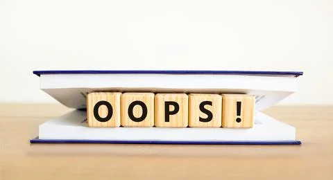 Oops symbol. Concept word Oops on beautiful wooden blocks in book. Beautifu.. Stock Photos