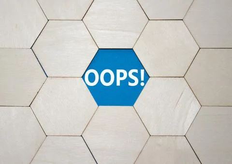 Oops symbol. Concept word Oops on wooden comb puzzle. Beautiful blue backgrou Stock Photos