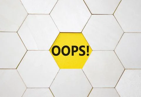 Oops symbol. Concept word Oops on wooden comb puzzle. Beautiful yellow back.. Foto stock