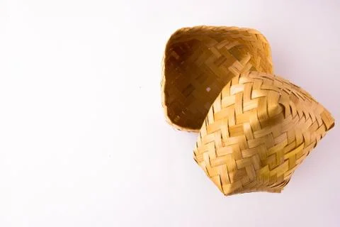 Op view of empty small hand-woven bamboo wicker container with lid partly opened Foto stock