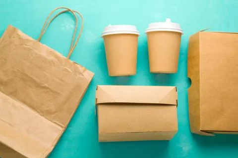 Op view flat lay recyclable types of paper  packaging on a blue background, p Stock Photos
