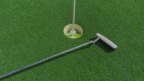 Op view of a golf putter lying next to a hole on a green mini golf course Stock Photos