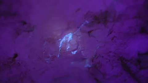 Opal vein being found in a mining tunnel in Coober Pedy using a UV light, South  Stock Footage 115435042