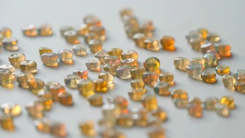 Opals gemstone from Ethiopia rotates on light background. White fire opals Stock Footage 121574427