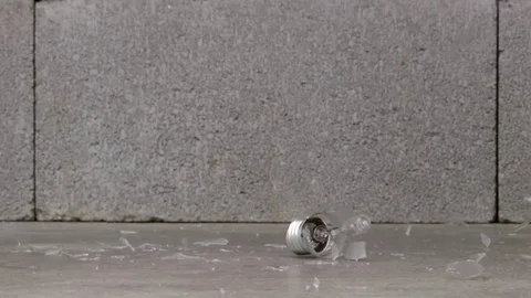 Opaque light bulb shattering on concrete Video stock 75344535