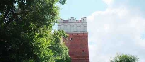 Opatowska Gate in Sandomierz — brick tower, leafy trees, cobblestone path Stock Footage 319556428