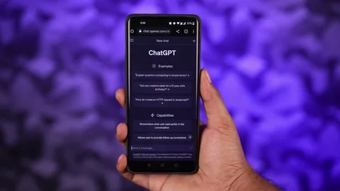 Open Ai ChatGPT on Phone Screen Holding in Hand at Abstract Blue Background Stock Footage 238668014