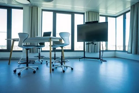 Open-air collaborative meeting space with tables chairs laptop Stock Photos