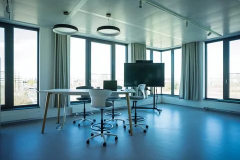 Open-air collaborative meeting space with tables chairs laptop Stock Photos