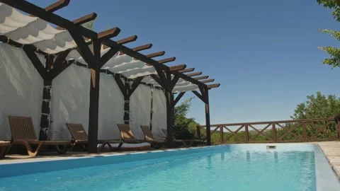 Open-air pool with clear blue water on the background of a mountain-forest Stock Footage 147409920