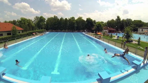 Open-Air Swimming Pool with Jumping Children Stock Footage 49029944
