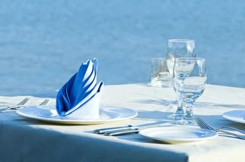 Open-air table setting for meals with elegant dishware Stock Photos