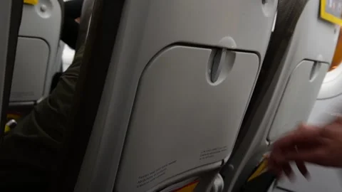 Open airplane seat table Stock Footage 173453628