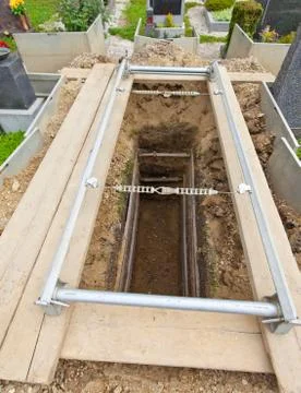 Open and empty grave in a cemetery Stock Photos