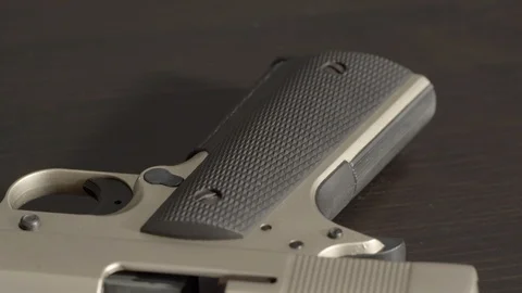 Open and empty pistol, tilting from grip to chamber Stock Footage 100245234