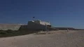 Open area within walls of Sagres castle Portugal with flag 4k 4k or 4k+ Resolution