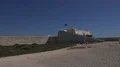 Open area within walls of Sagres castle Portugal with flag 4k 4k or 4k+ Resolution