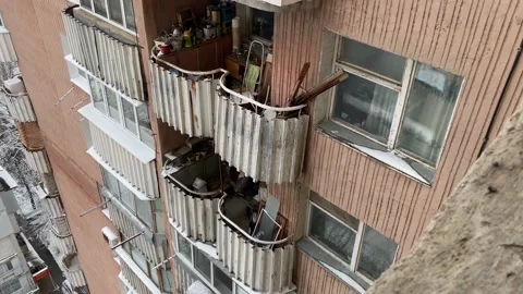 Open balcony with old stuff on a multi-story apartment building facade Stock Footage 147981592