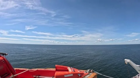 Open Baltic Sea horizon view from ferry ship deck with orange lifeboat Stock Footage 340329617