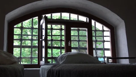Open barred window and beds in prison cell Video stock 118234906