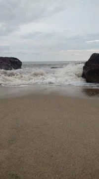 An open beach between two rocks Stock Photos