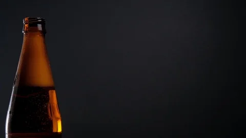 Open beer bottle with foam Stock Footage 125373617