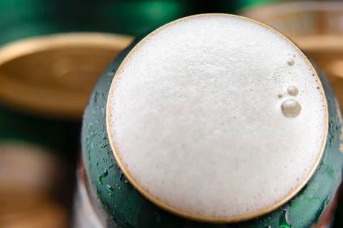 Open beer can with foam on the surface Stock Photos