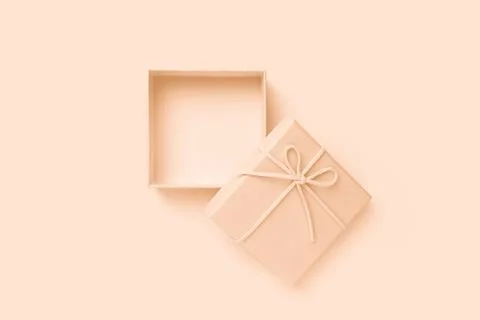 Open beige square gift box with a bow, top view Stock Photos