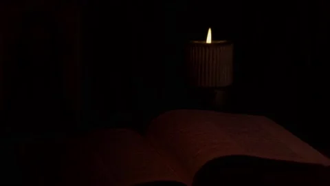 An Open Bible And A Burning Candle In The Church. Stock Footage 146071630