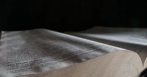 Open Bible book of John Jesus has risen macro slide  Stock Footage 257610443