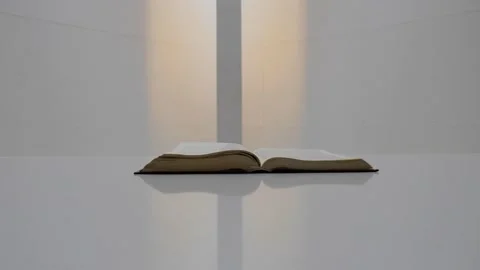 Open Bible Book on White Surface and Room Stock Footage 146408243