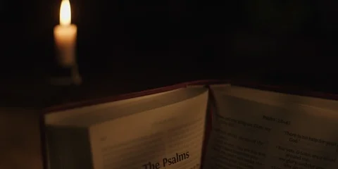 Open bible with candle Stock Footage 126077948